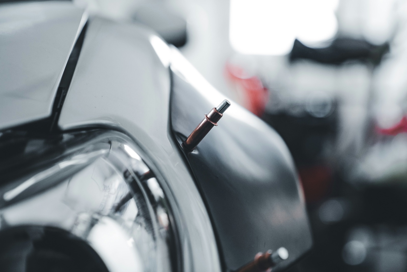 Spot-welding pins attached to a car body panel during collision repair